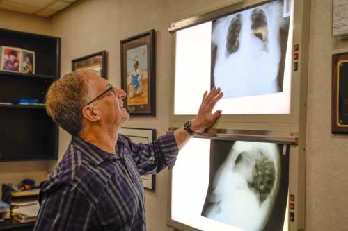 Photo of Dr. Barth looking at X-Rays