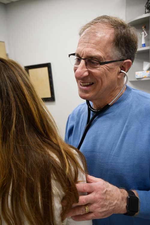 Image of Eric R. Barth, MD interacting with a patient